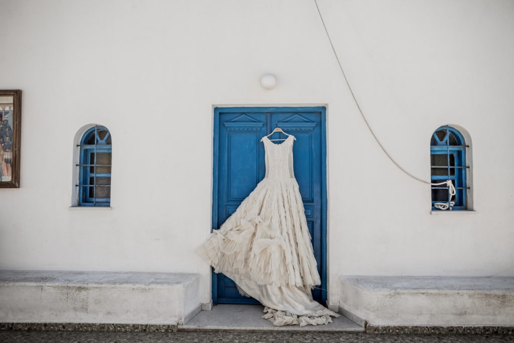 Bridal-gown-against-blue-door-Greek-villa