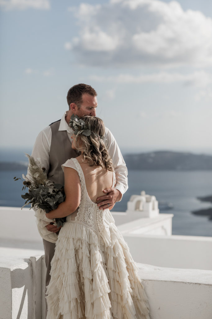 Bride and groom embrace after elopement ceremony in Greece