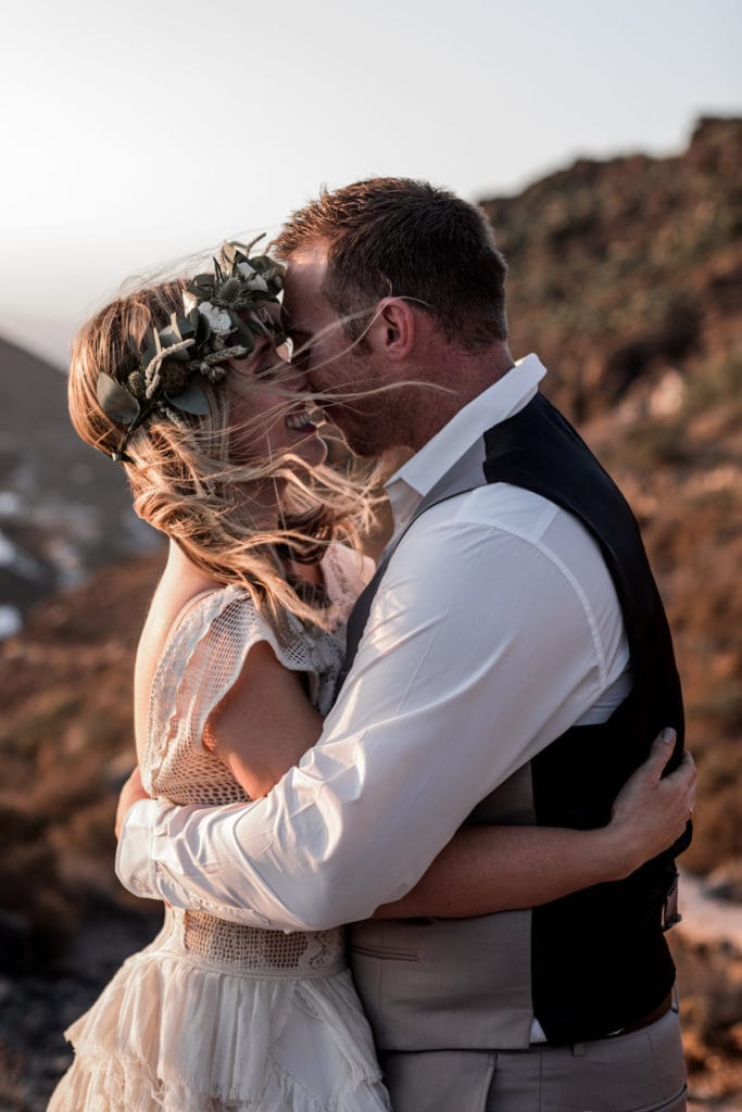 Bride and groom kiss portrait Santorini Greece elopement