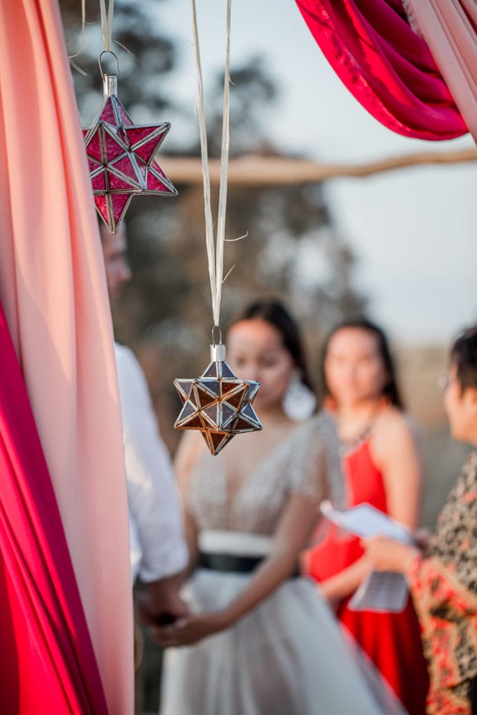 Moroccan lanterns hang from ceremony altar