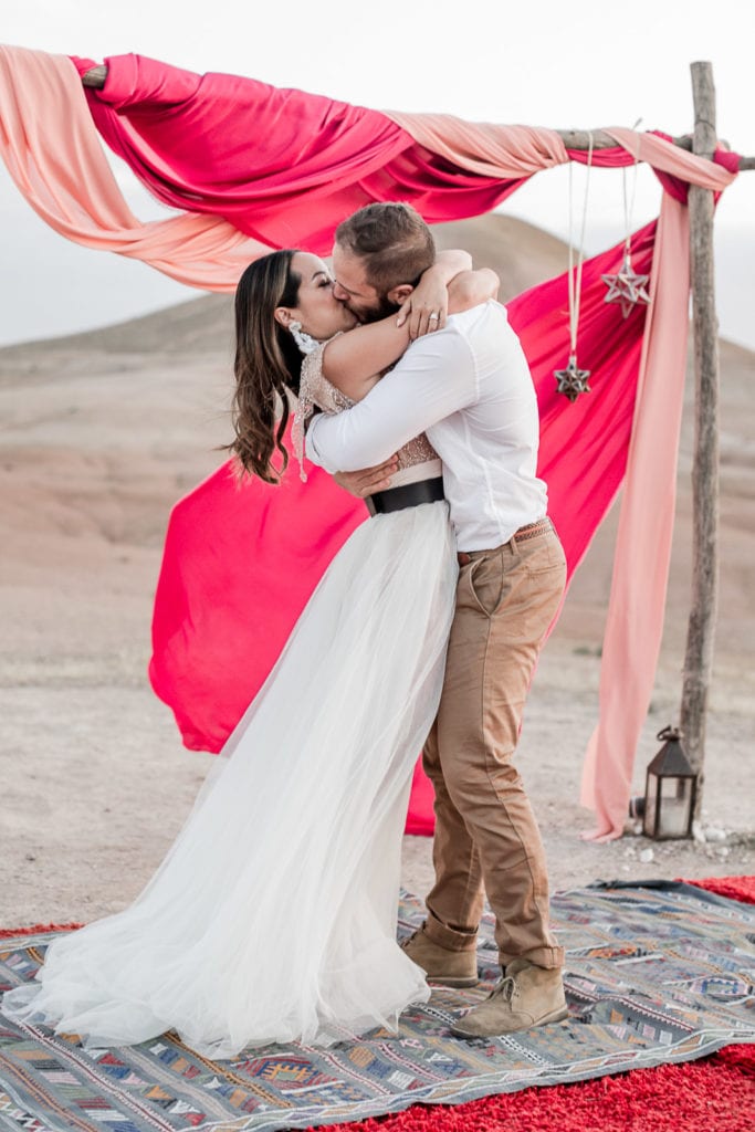 Bride and groom kiss during La Pause Marrakech destination wedding elopement ceremony