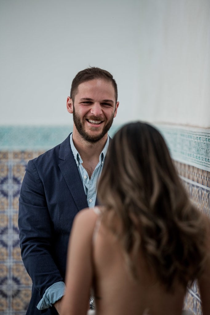 Groom looks at his bride for the first time at Be Riad in Marrakech, Morocco