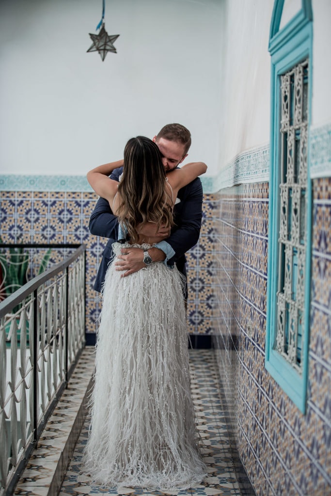 Bride and groom embrace during their first look at their Morocco wedding at Be Riad in Marrakech