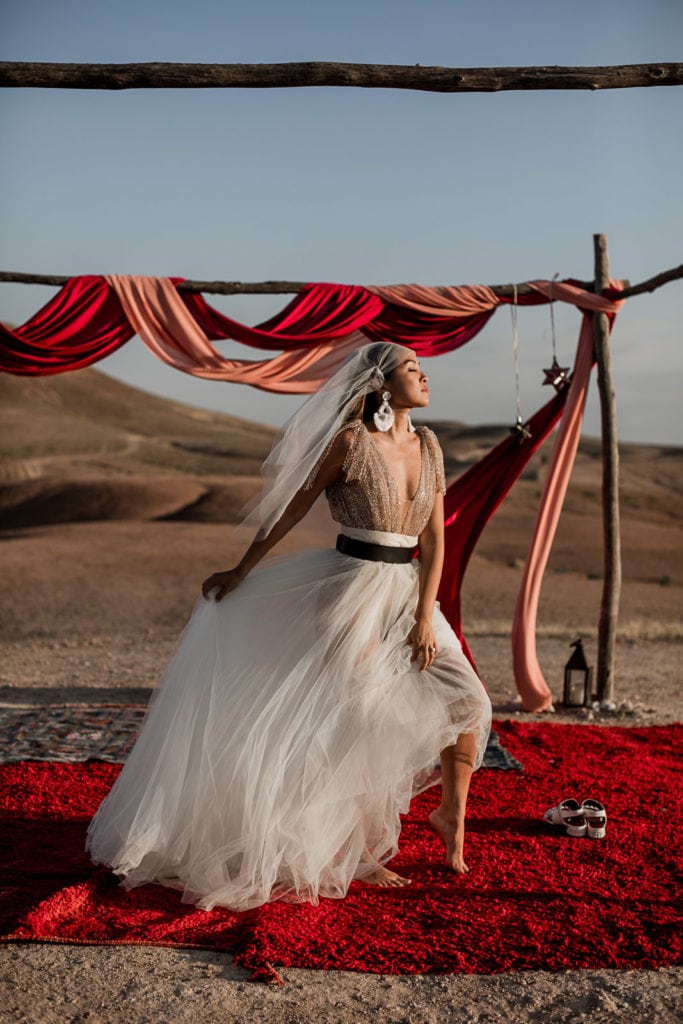 Bride shows her bridal gown at La Pause wedding ceremony in Morocco elopement