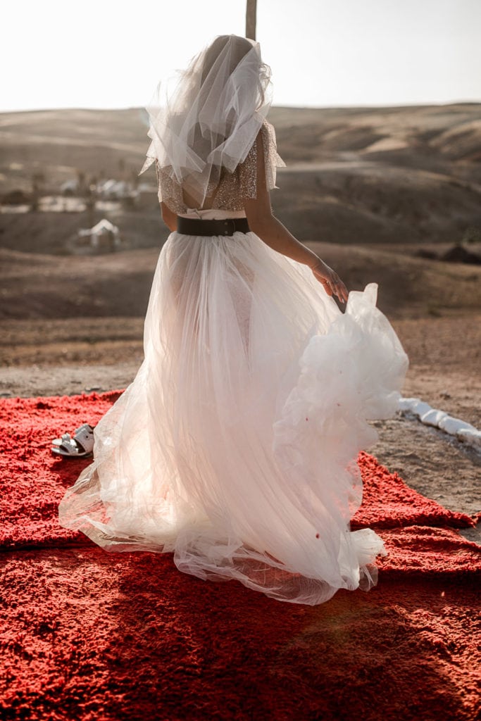 Bride shows her dress during La Pause wedding ceremony in Marrakech elopement