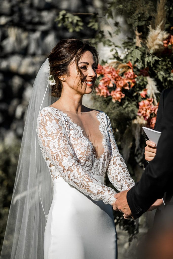 Bride holds hands of groom during Portofino, Italy wedding