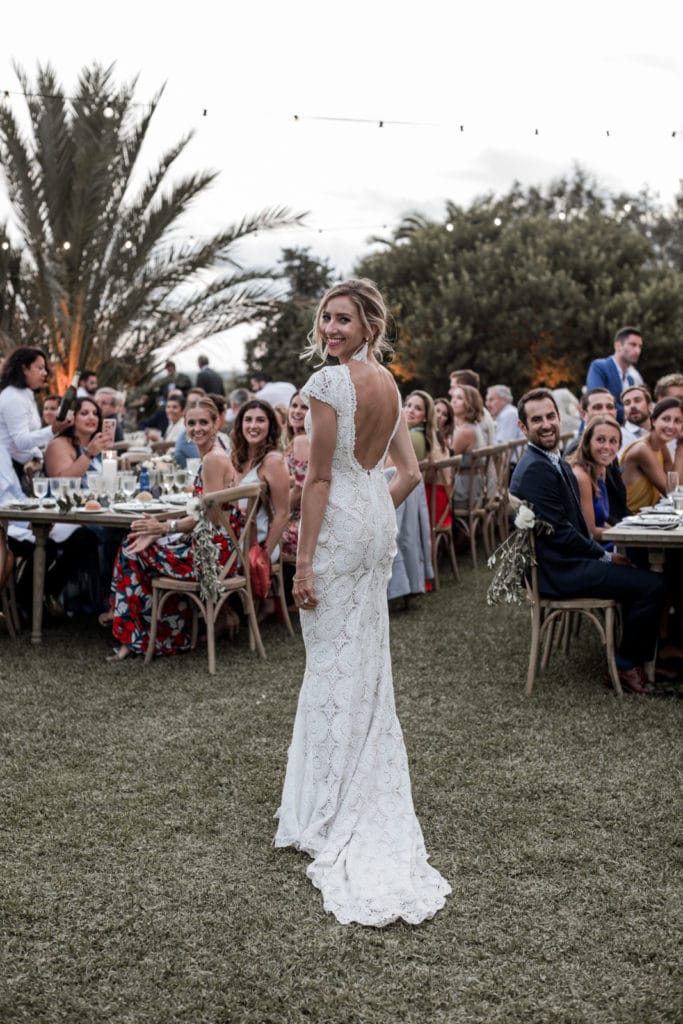 Bride turns to look at camera as she enters wedding reception in Mallorca Spain