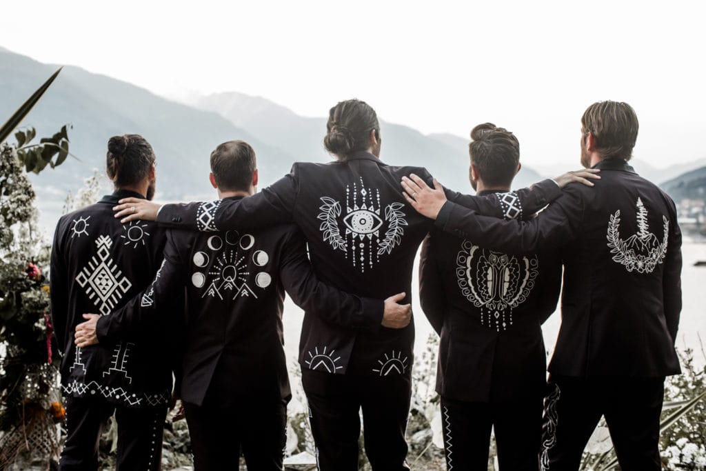 Groomsmen stand together overlooking Lake Como at Villa Camilla in their Southwestern-inspired jackets