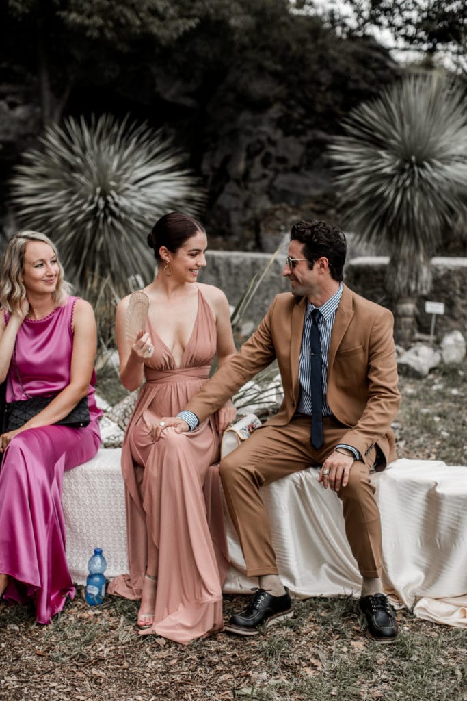 Fashionable guests wait for ceremony to start at Giardini del Merlo