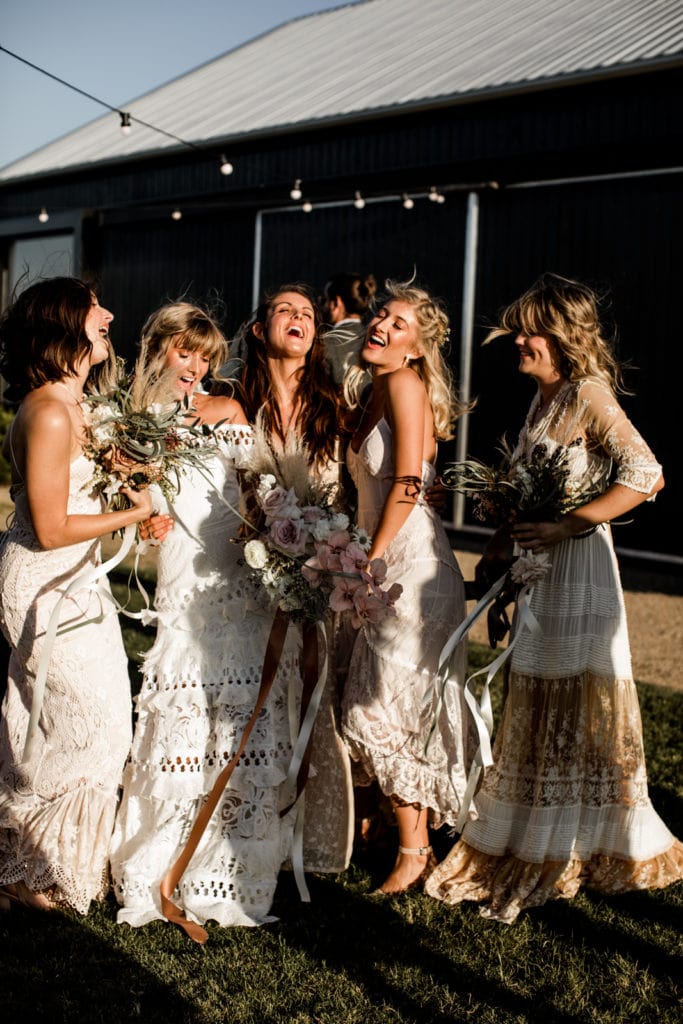 Bride and bridesmaids celebrate together before wedding ceremony