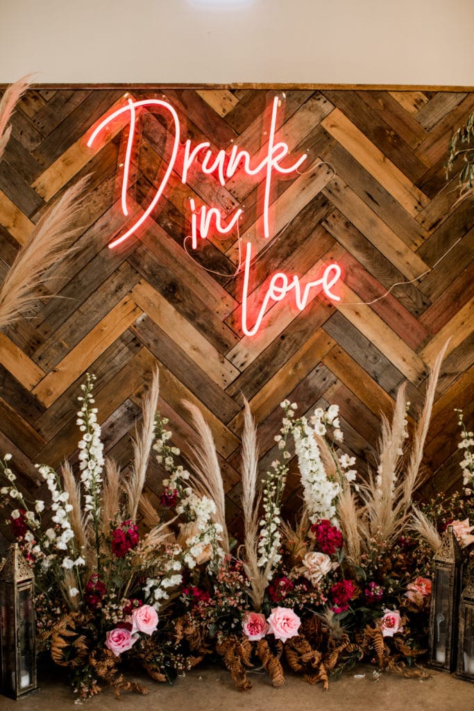 Neon "Drunk in Love" bar sign at Byron Bay wedding reception