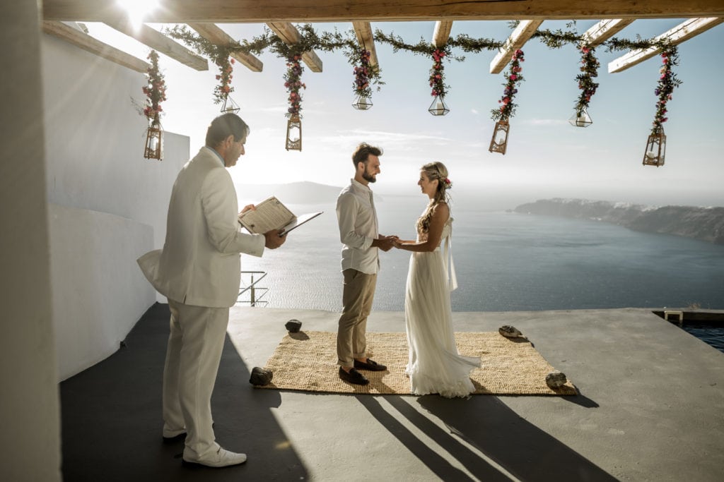 Private Santorini elopement ceremony on private balcony at sunset in Greece