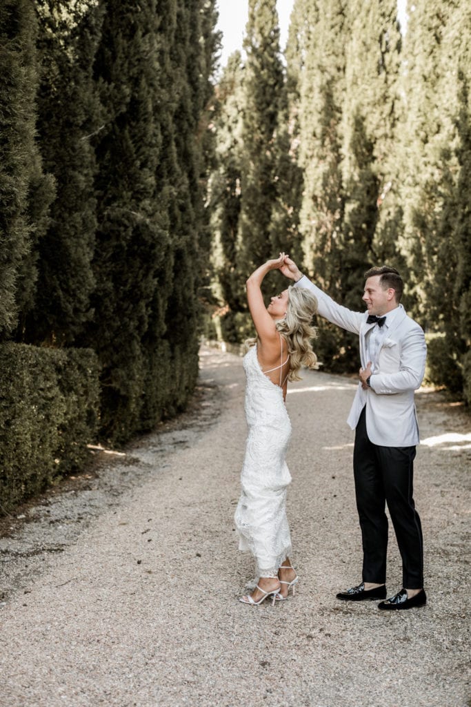 Groom dances with bride during first look at destination wedding in Tuscany