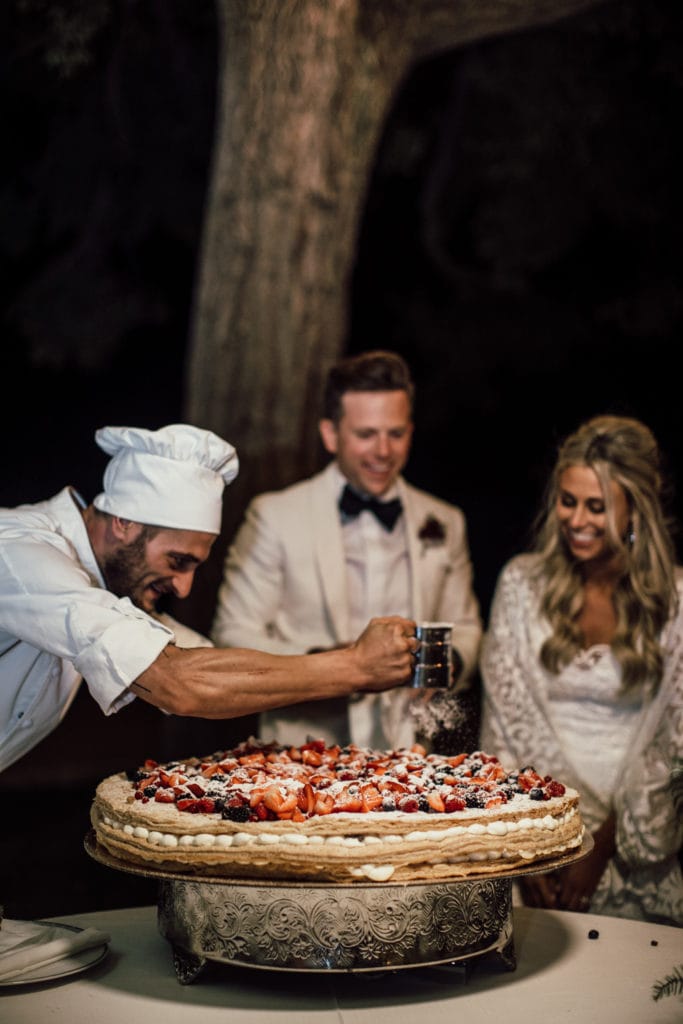 Traditional Italian pastry chef creates wedding cake at wedding reception in Tuscany