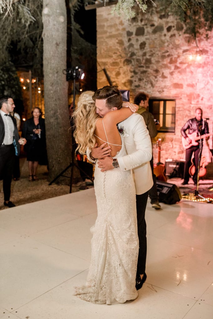 Bride and groom dance together at outdoor wedding reception