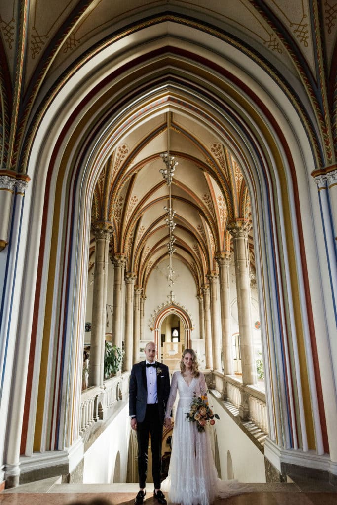 Bride and groom stand together after Vajdahunyad Castle destination Budapest wedding