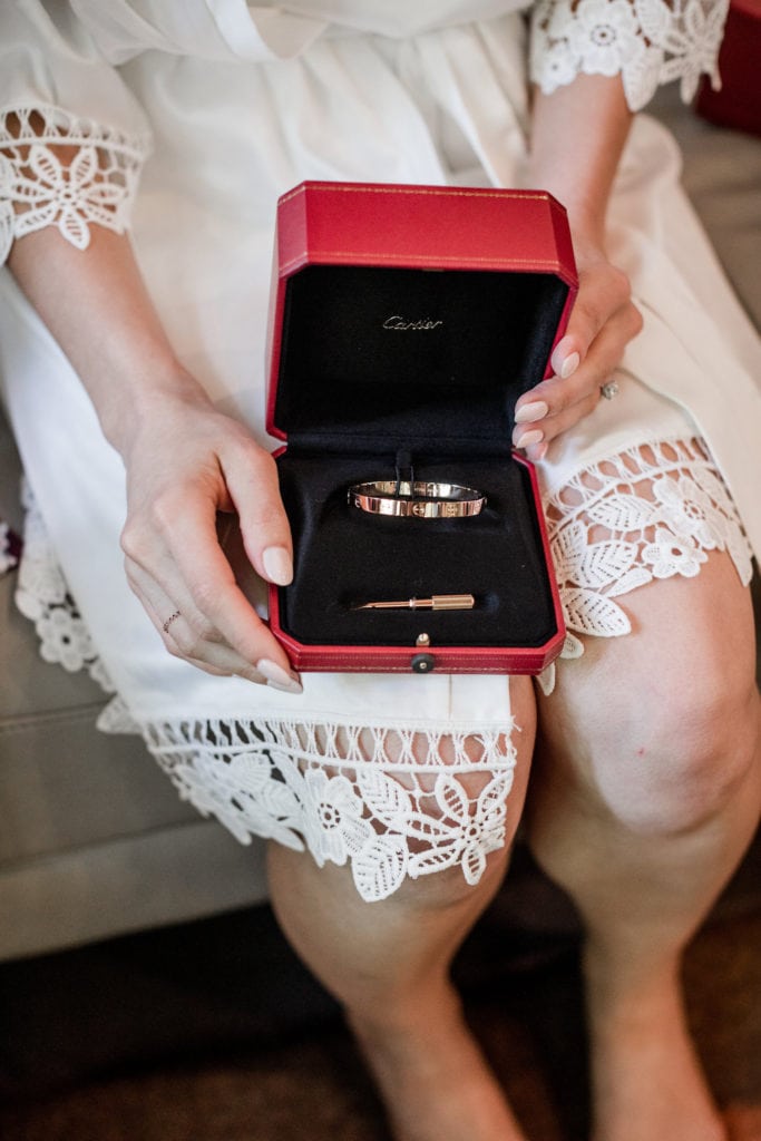 Bride shows her gift from her groom, a Cartier bracelet