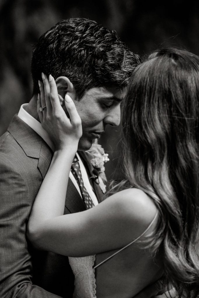 Bride touches groom's face during first look in Big Sur, California