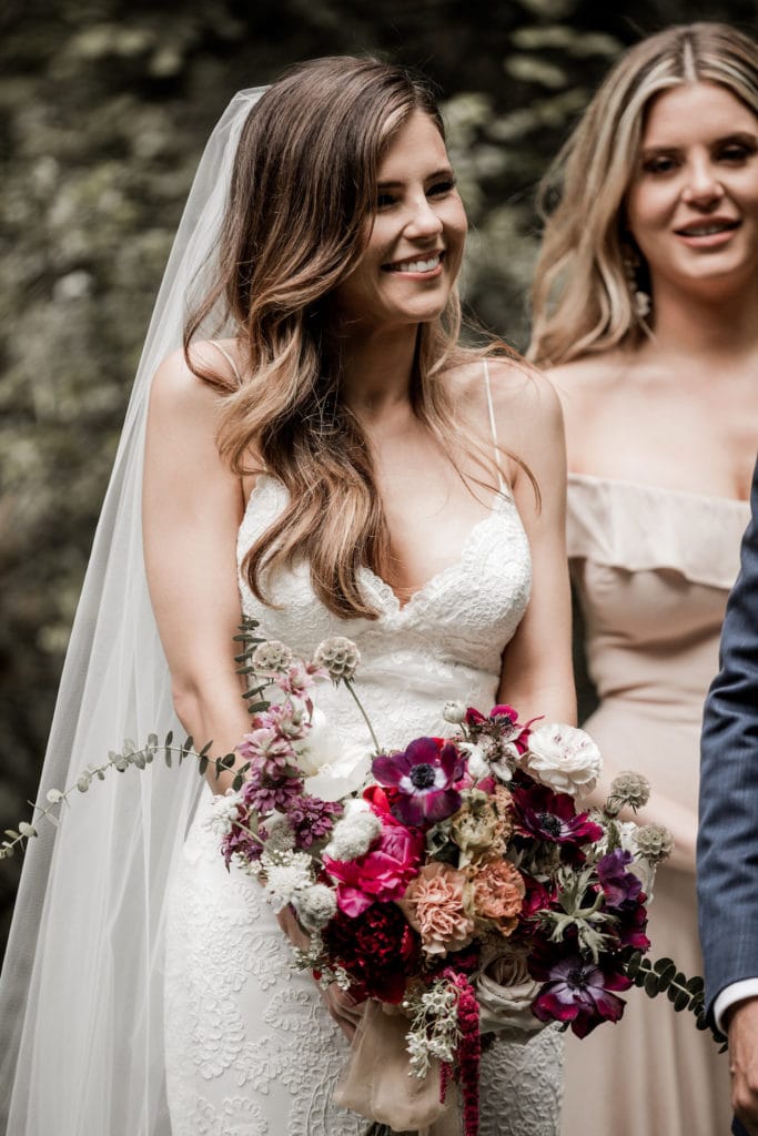 Bride looks at groom with adoration during Big Sur wedding ceremony