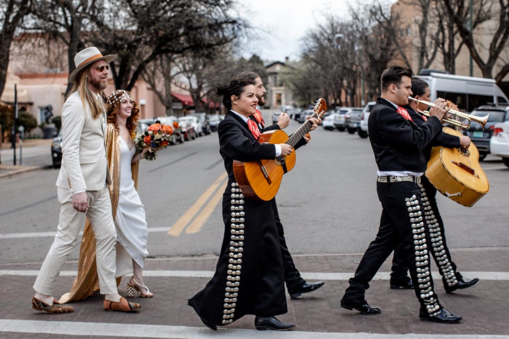 Mariachi band plays as bride and groom walk to their reception after New Mexico wedding ceremony