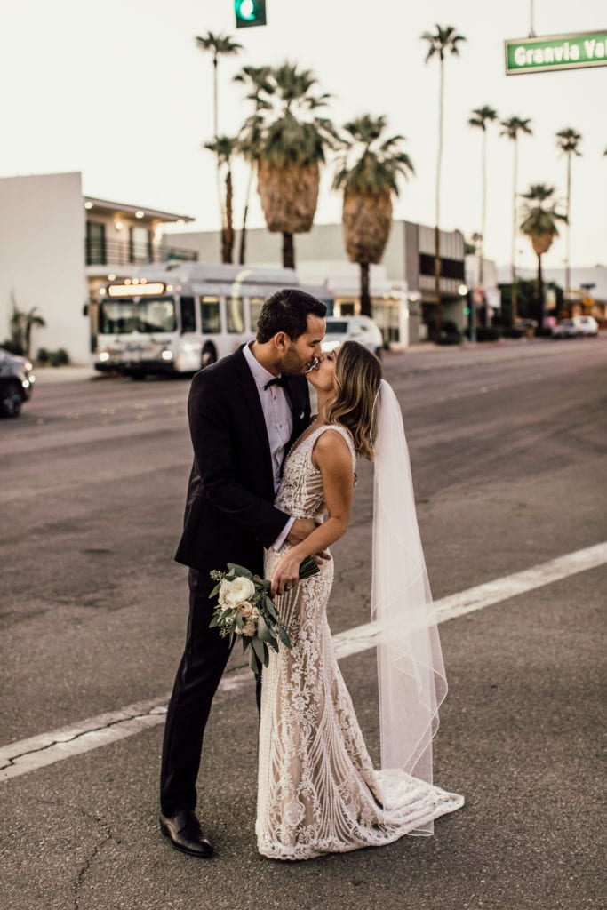 Bride and groom kiss downtown Palm Springs