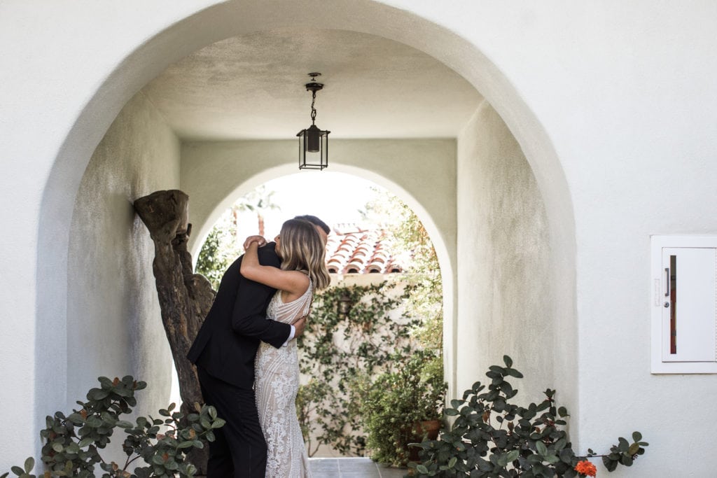 Bride and groom embrace during first look at Palm Springs wedding