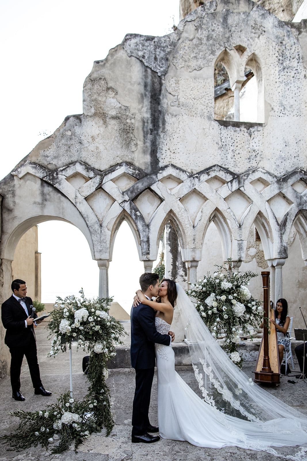 Bride and groom kiss after wedding ceremony at Grand Hotel Convento