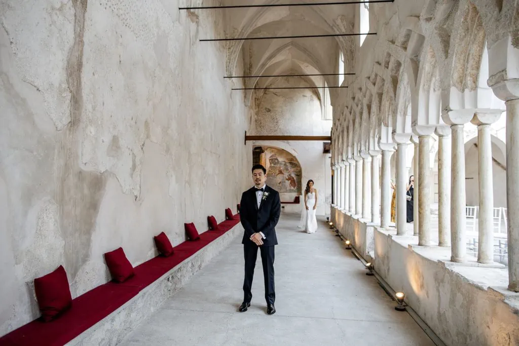 Bride walks to groom during first look at Amalfi Italy Convento wedding
