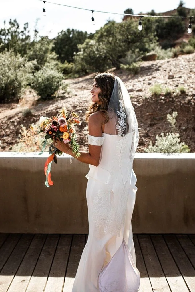 Bride in Vera Wang bridal gown stands outside at Santa Fe New Mexico wedding
