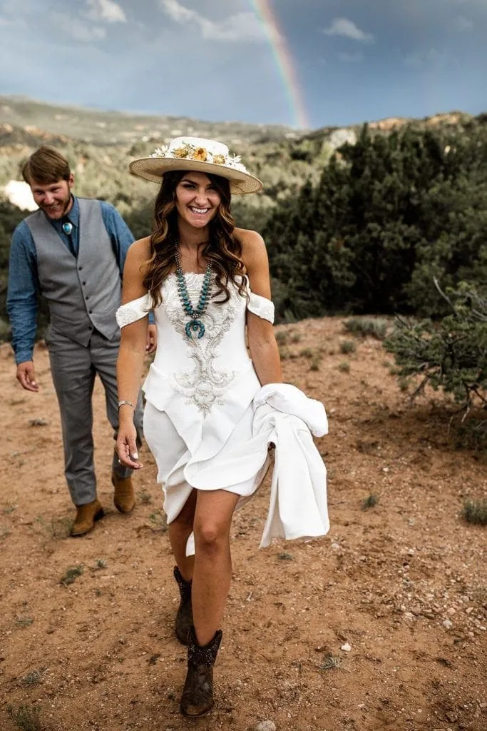 Bride wears Vera Wang bridal gown with cowboy boots and turquoise necklace for Santa Fe wedding