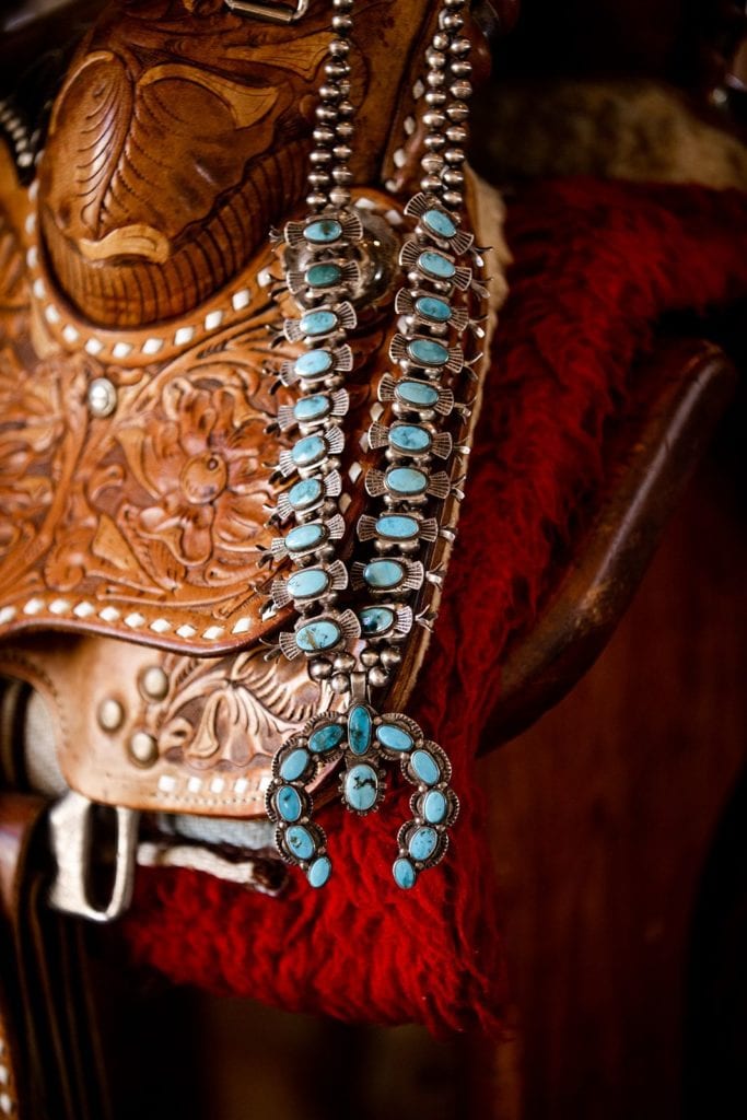 Turquoise statement necklace against leather saddle