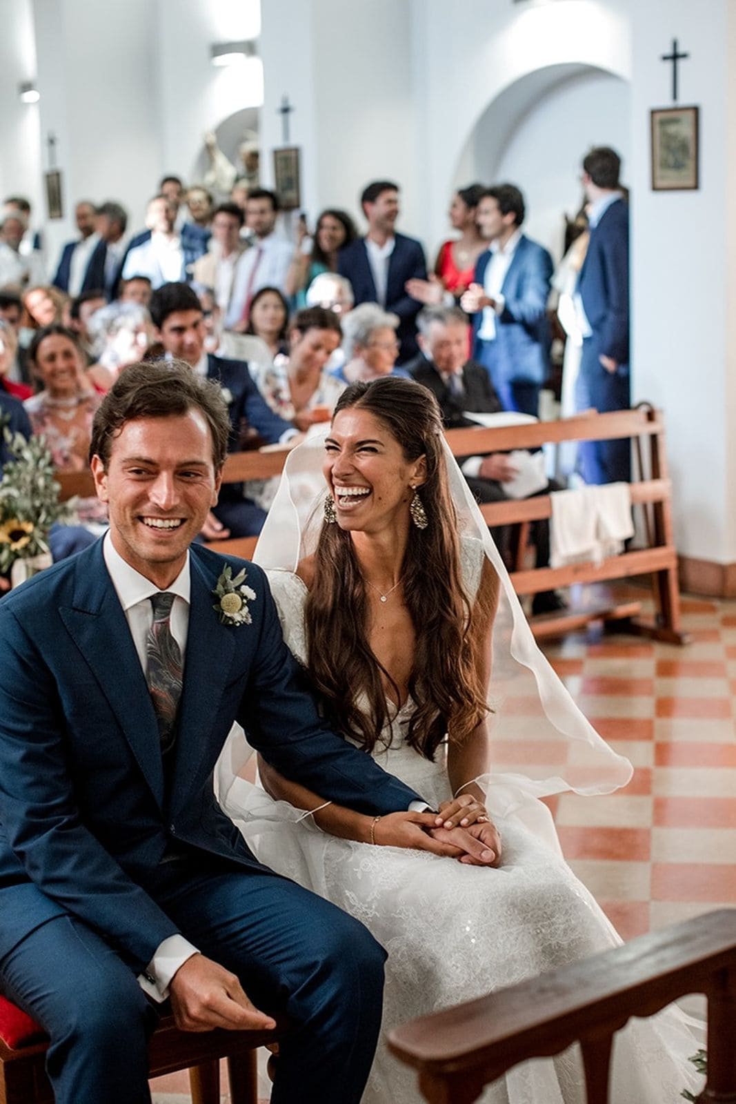 Bride and groom laughing during traditional Catholic wedding mass ceremony