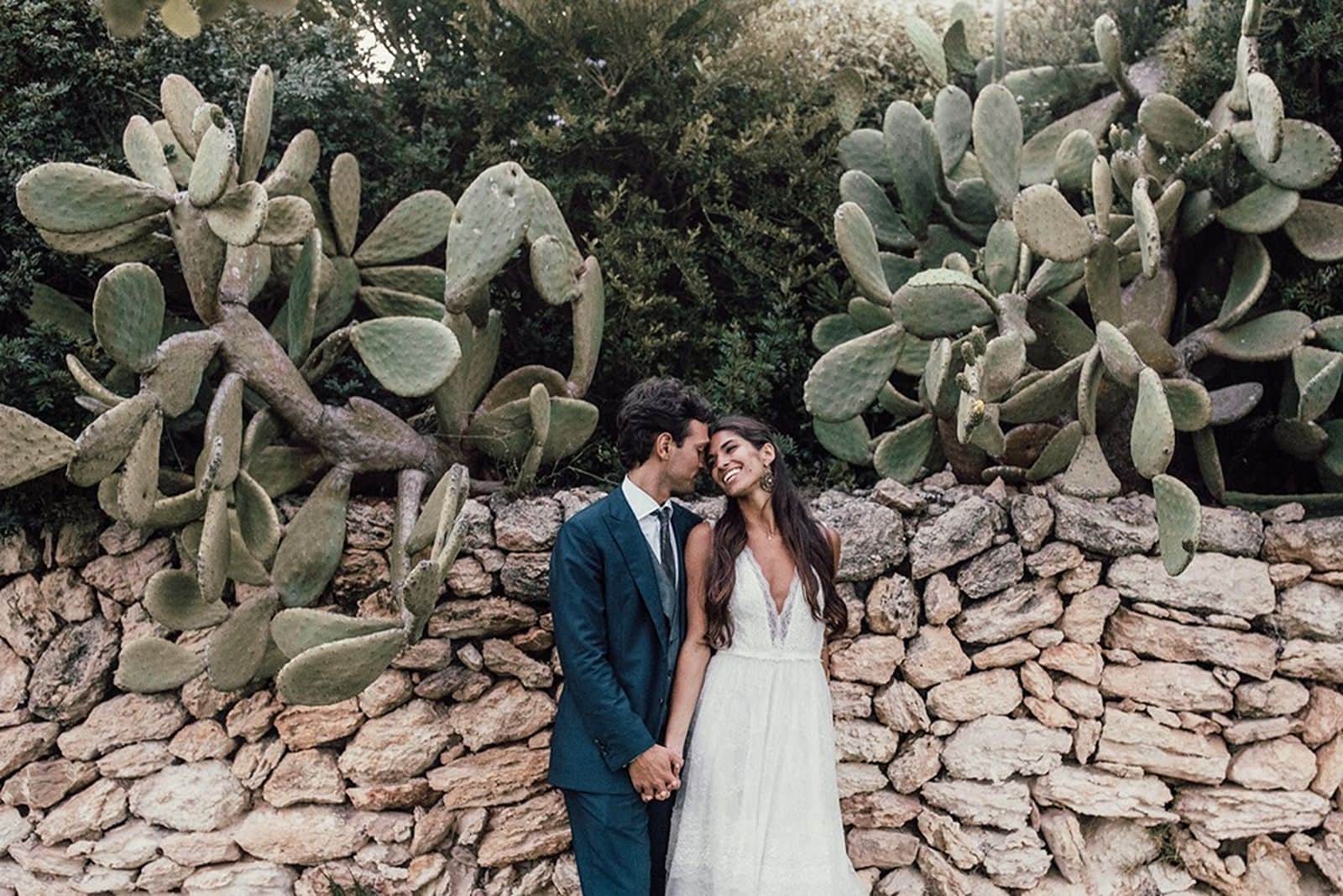 Bride and groom portrait in front of cacti