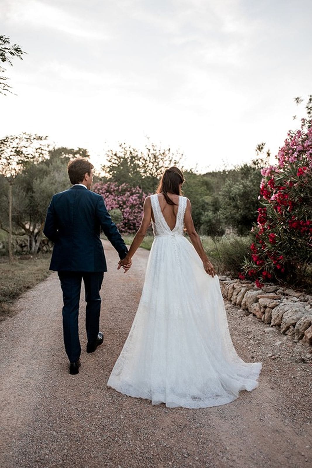 Bride and groom walk hand in hand after Ibiza wedding ceremony