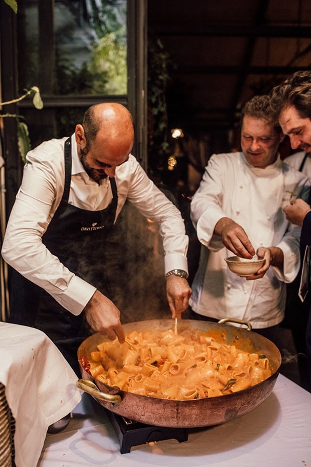 Chef prepares pasta at wedding reception