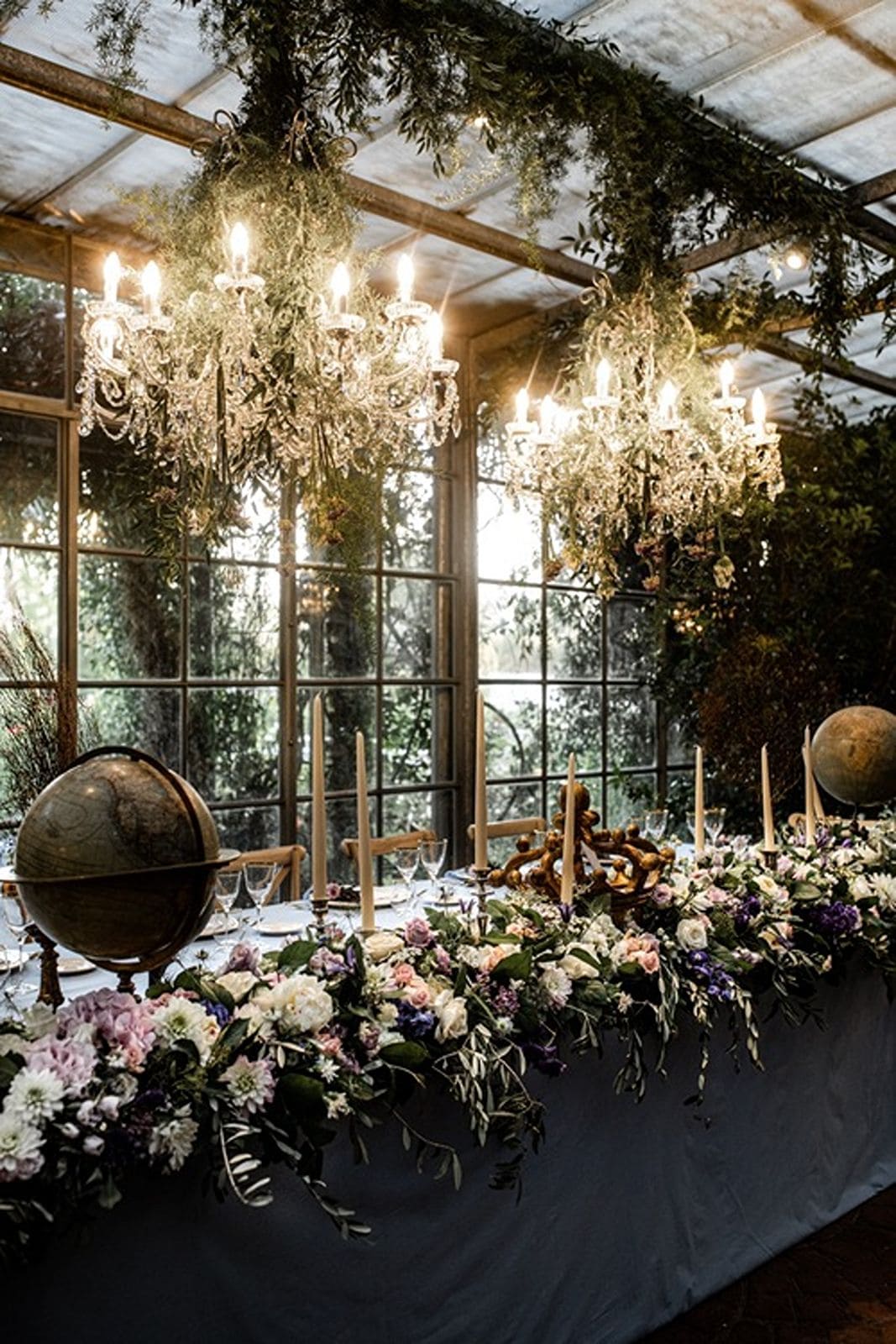 Chandeliers illuminate wedding reception tables