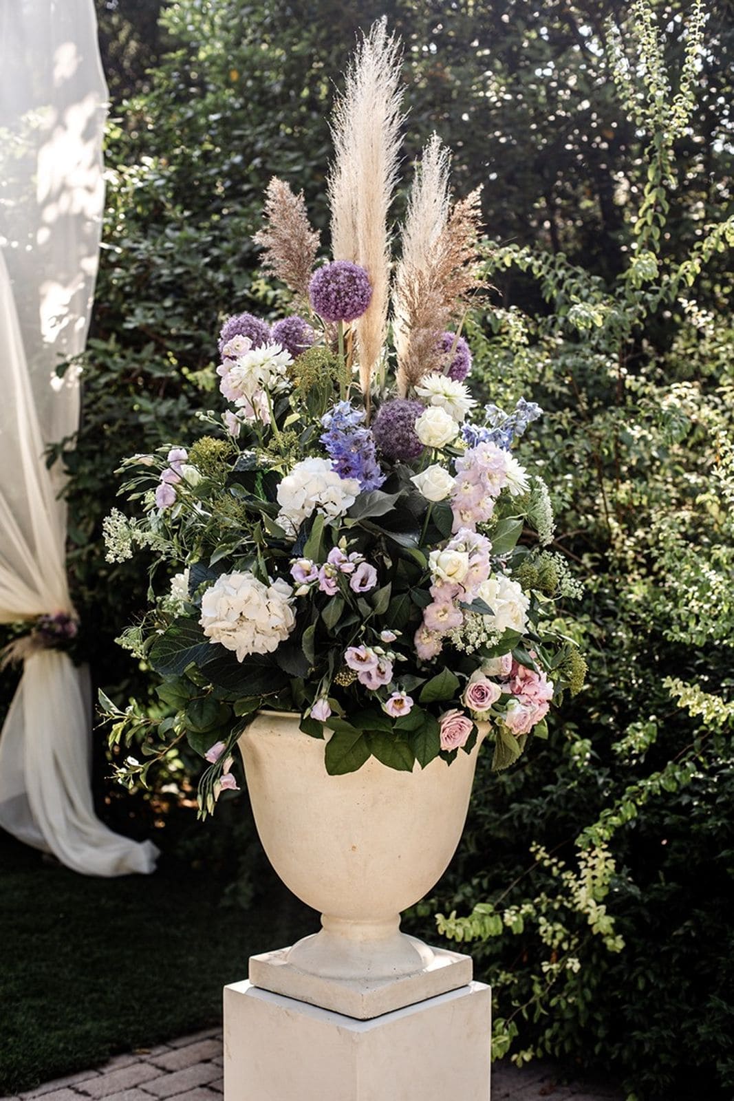 Lavender and white wedding ceremony floral arrangement