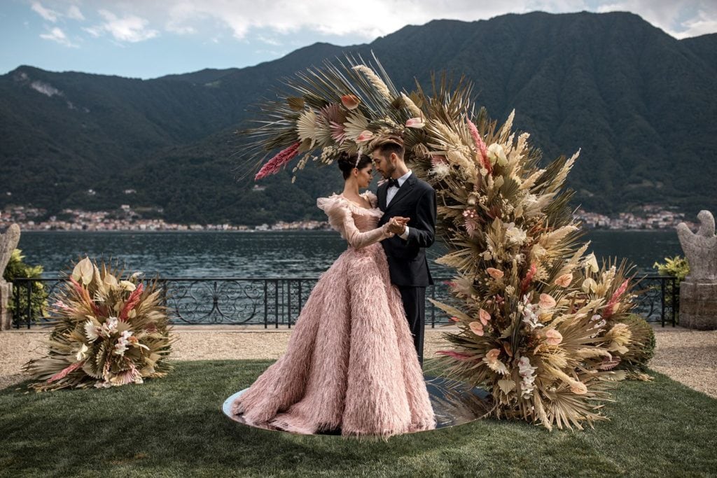 Bride and groom stand together at floral ceremony arch for Elopement in Lake Como at Villa Balbiano