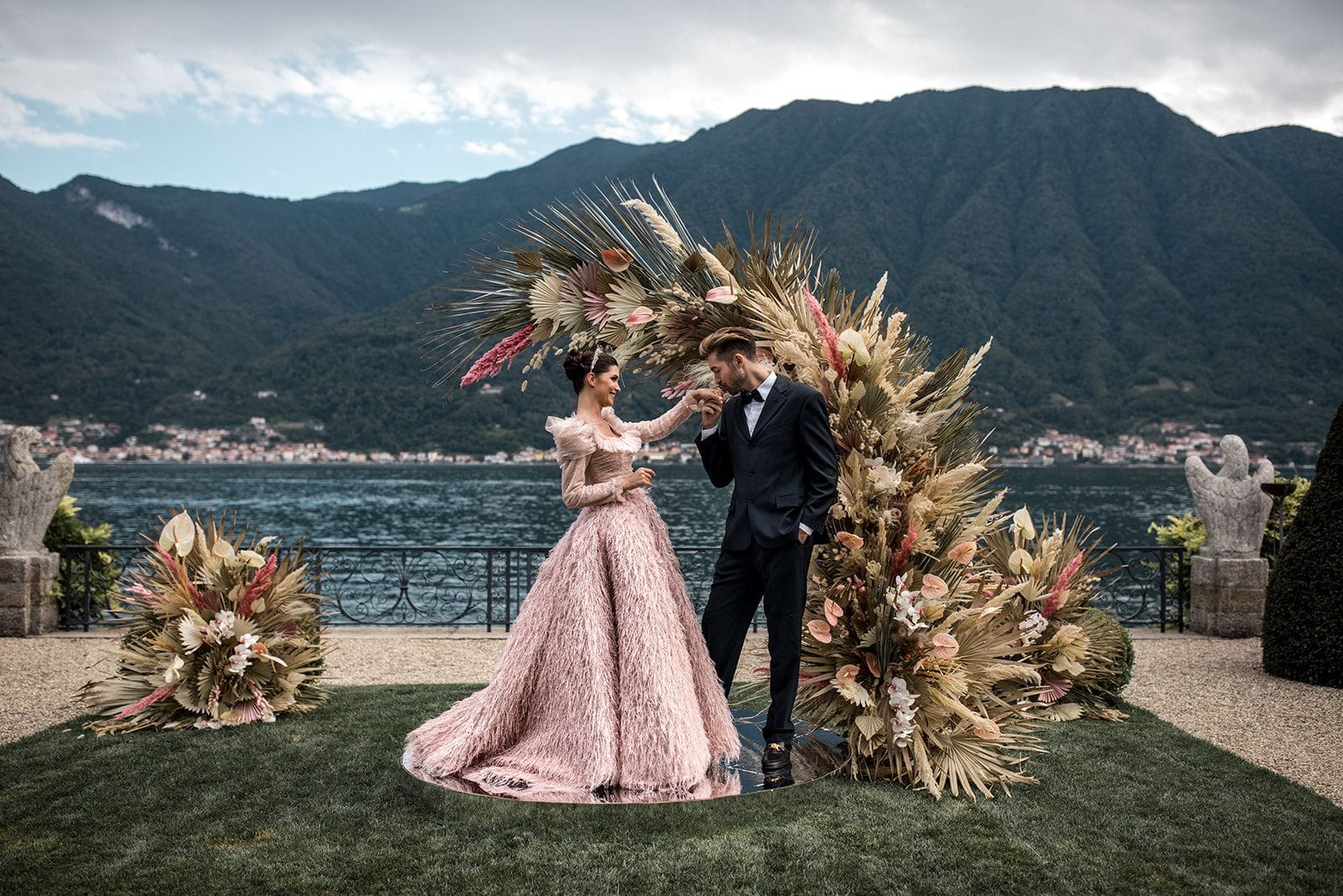 Couple stand at floral ceremony site during elopement in Lake Como