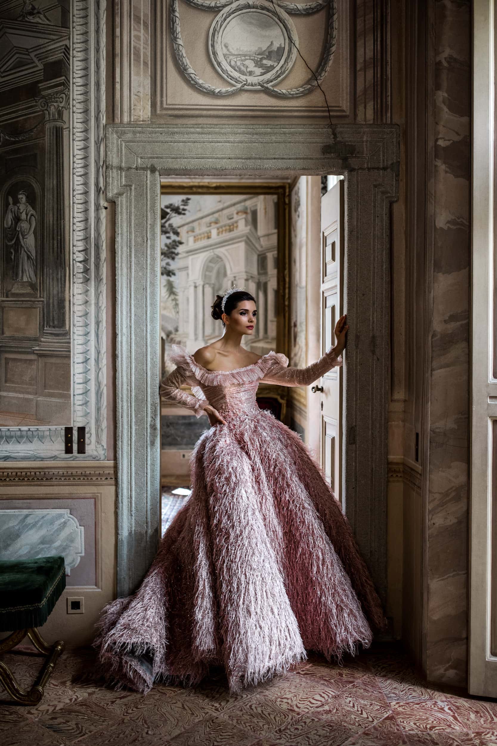 Woman stands in doorway of Villa Balbiano in haute couture Sara Mrad bridal gown
