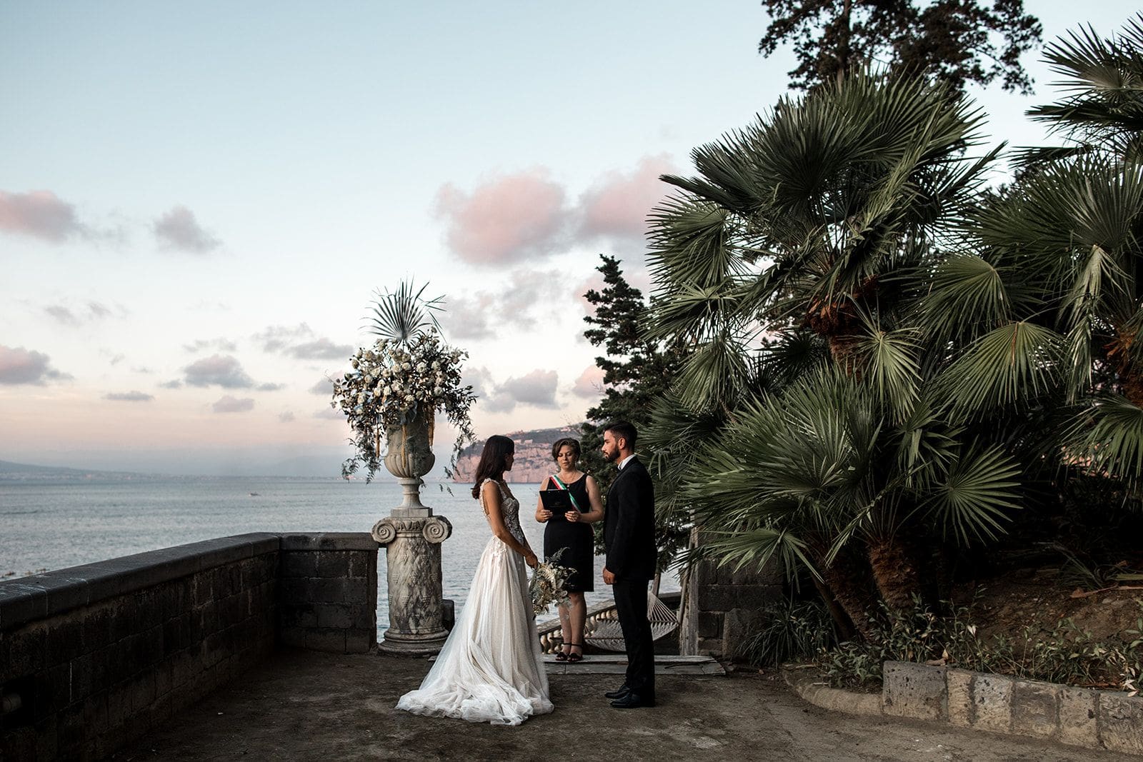 Bride and groom stand with officiant at Villa Astor Amalfi Coast elopement ceremony