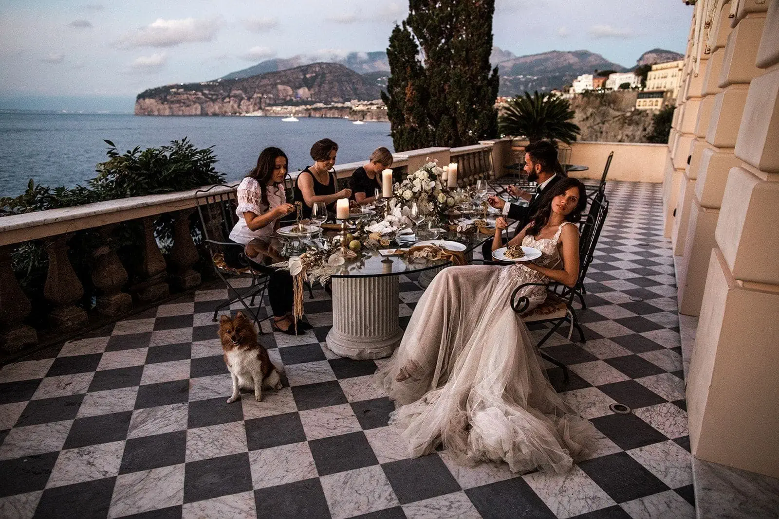 Guests gather at small table for Amalfi Coast elopement intimate reception
