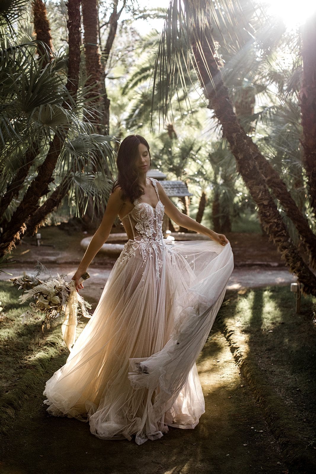 Bride twirls dress amidst foliage of Villa Astor