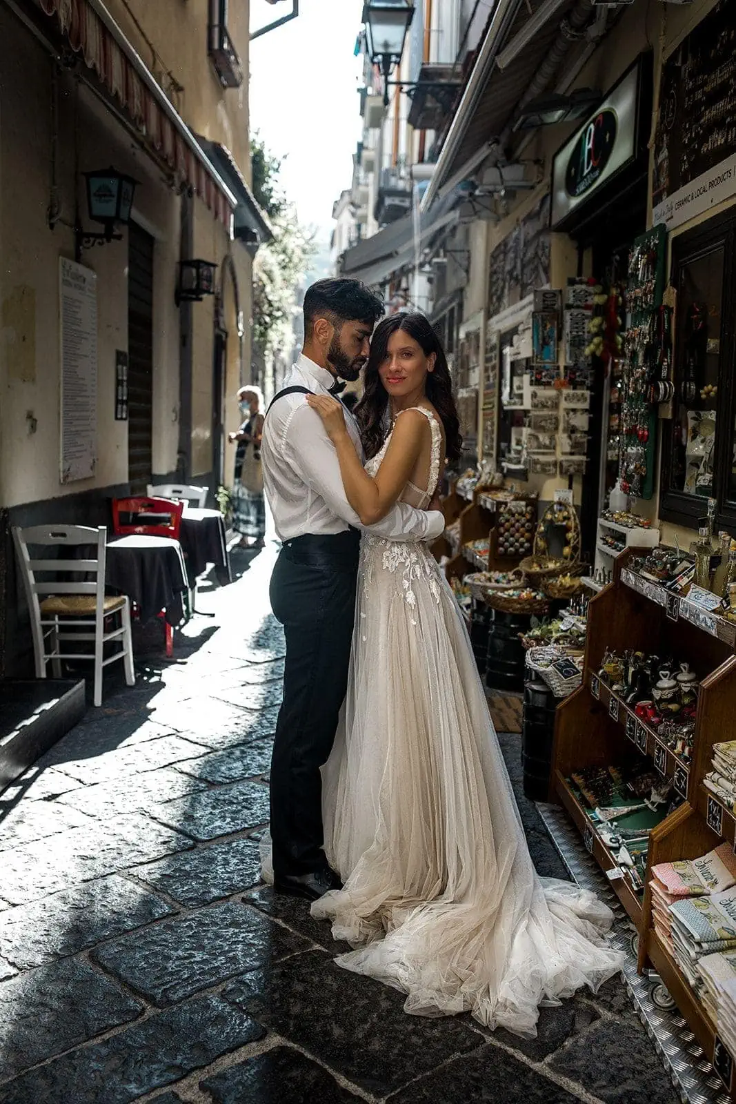 Bride and groom embrace in streets of Sorrento, Italy after elopement