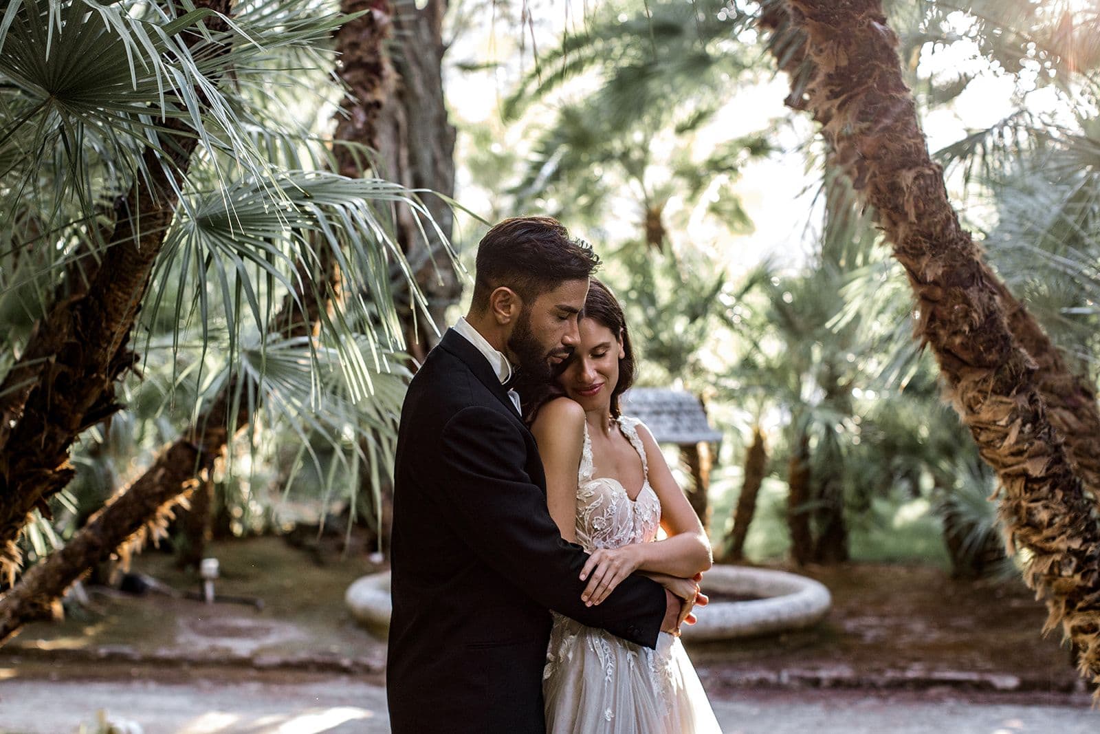 Bride and groom embrace in the tropical gardens of Villa Astor in Sorrento Italy