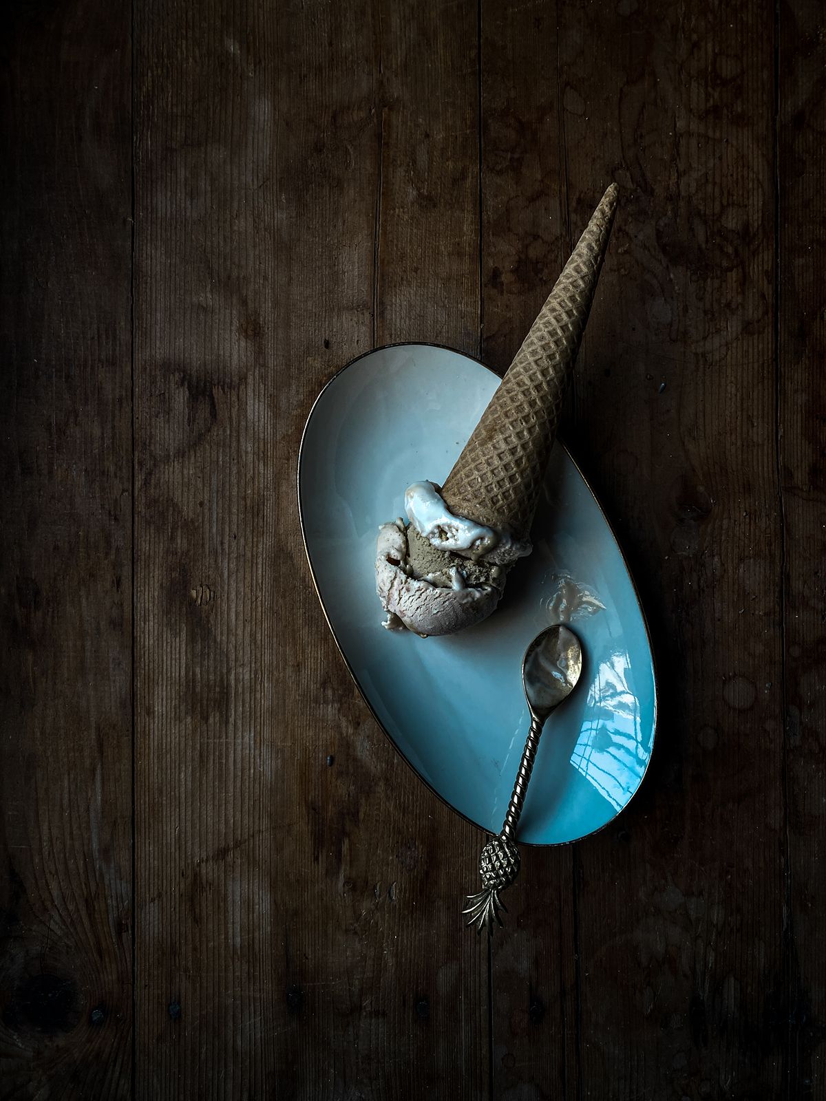 Gelato cone in a blue dish with a spoon