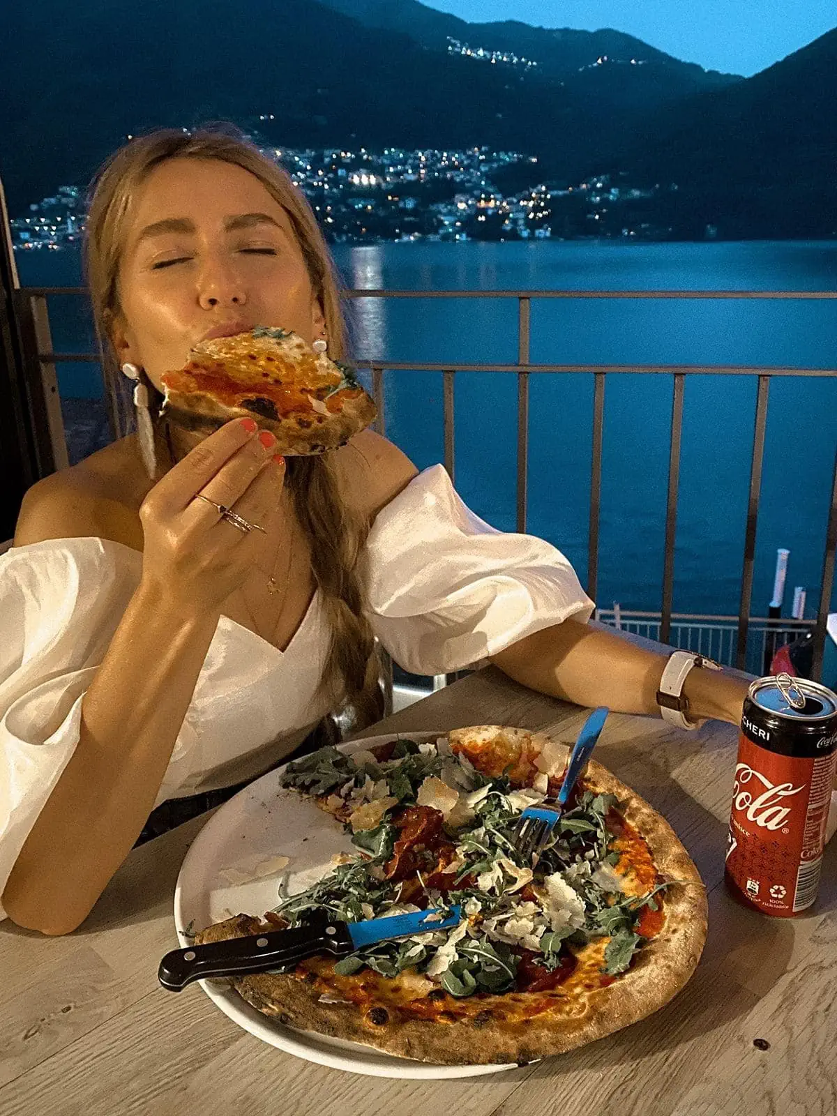 Woman eats authentic Italian pizza in Brienno to show people top unique things to do in Lake Como