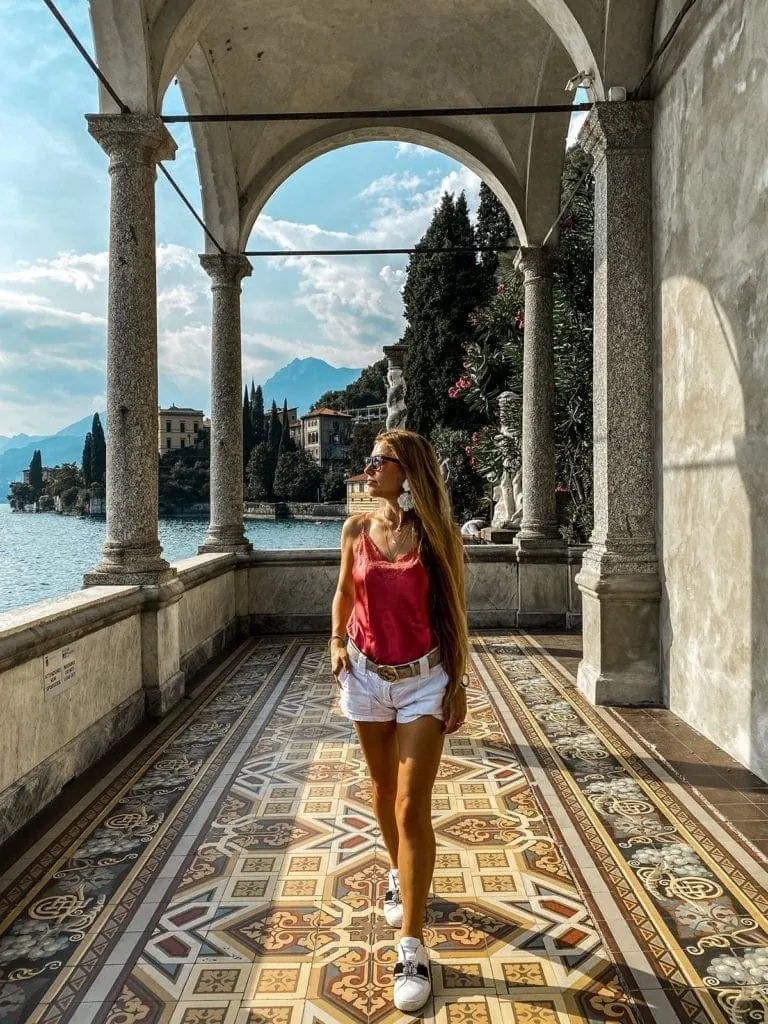 Woman walks through Villa Monastero in Lake Como Italy