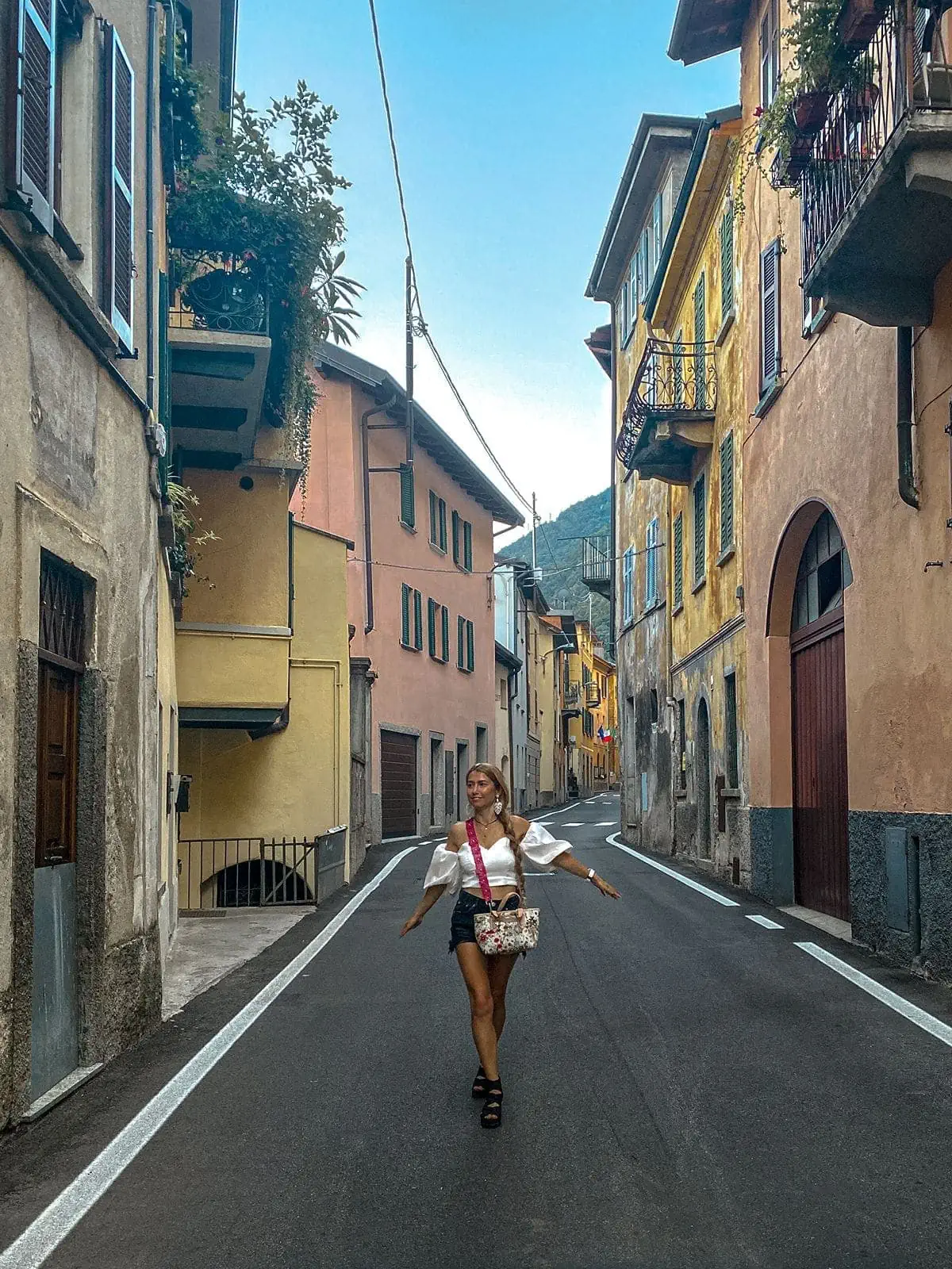 Woman walks streets of Brienno Italy
