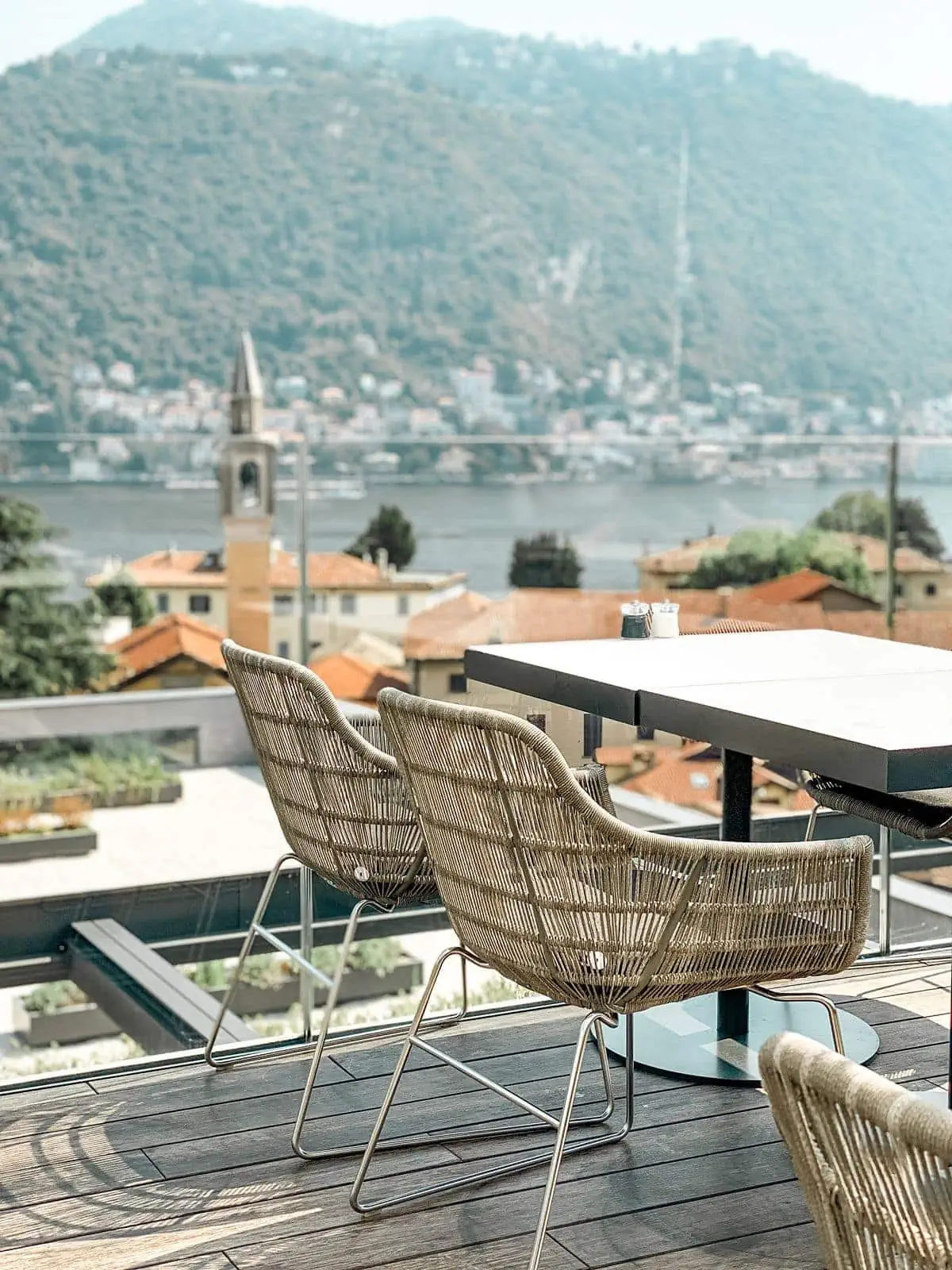 Outdoor terrace seating overlooking Lake Como at Hilton hotel